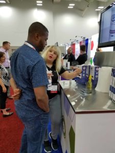 At IAFP 2019 - Tracy with a booth visitor demonstrating Indicon Gel 