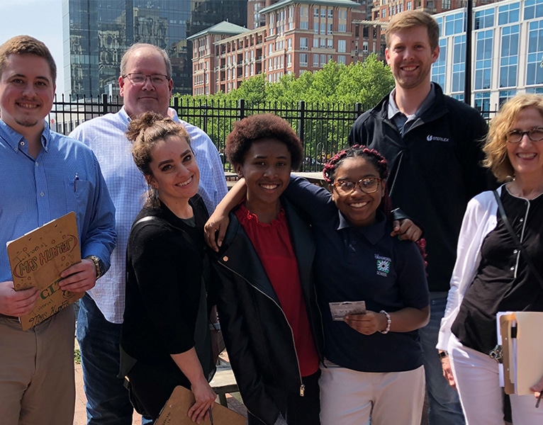 Five members of our R&D team pose with the two young women who won the 8th grade science fair as part of Living Classrooms at Crossroads school in Baltimore