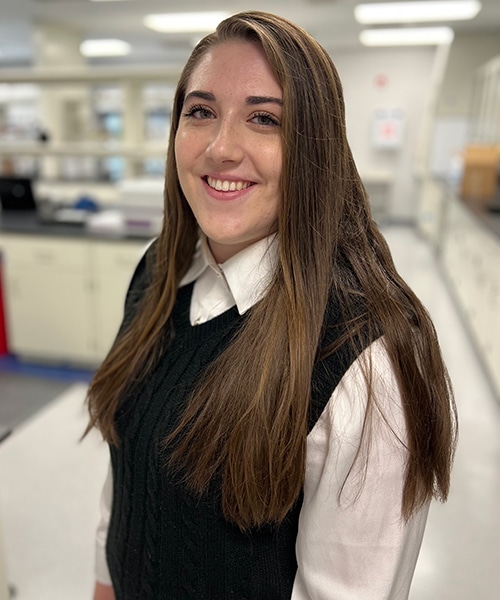 Rebecca Hallameyer with lab blurred in background