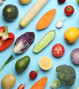 Birdseye view of fresh fruit and vegetables on blue table