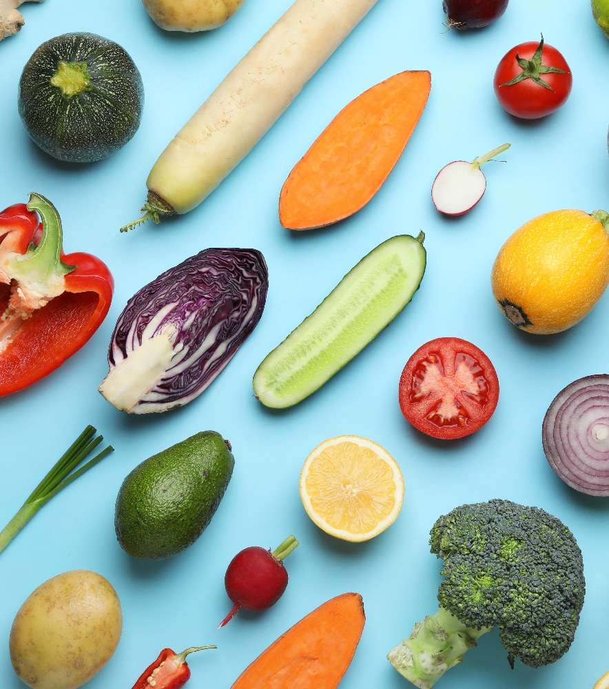 Birdseye view of fresh fruit and vegetables on blue table