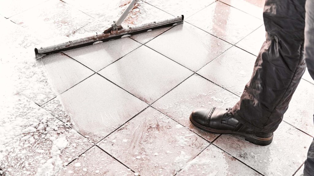 worker mopping foam product on the floor