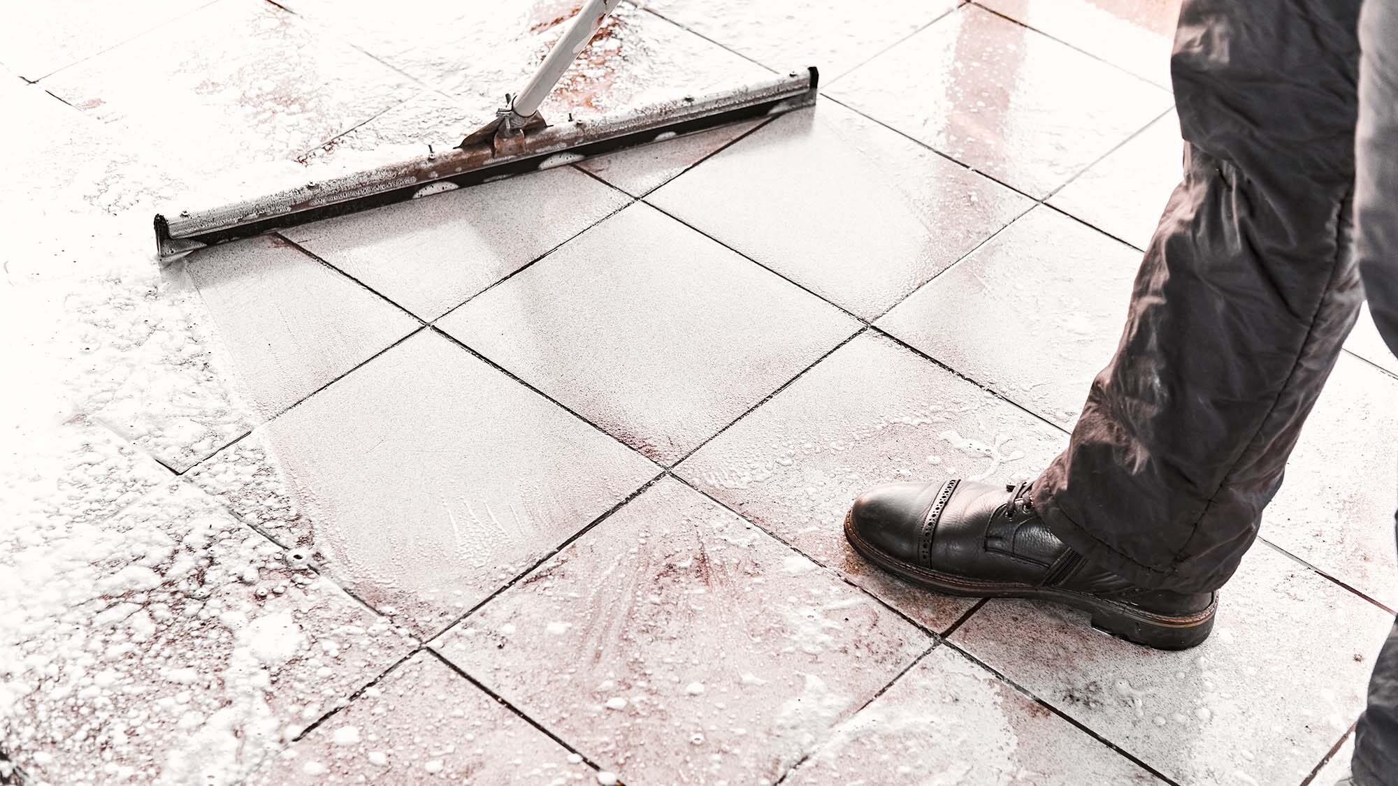worker mopping foam product on the floor