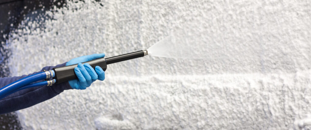 person spraying foam with wand product